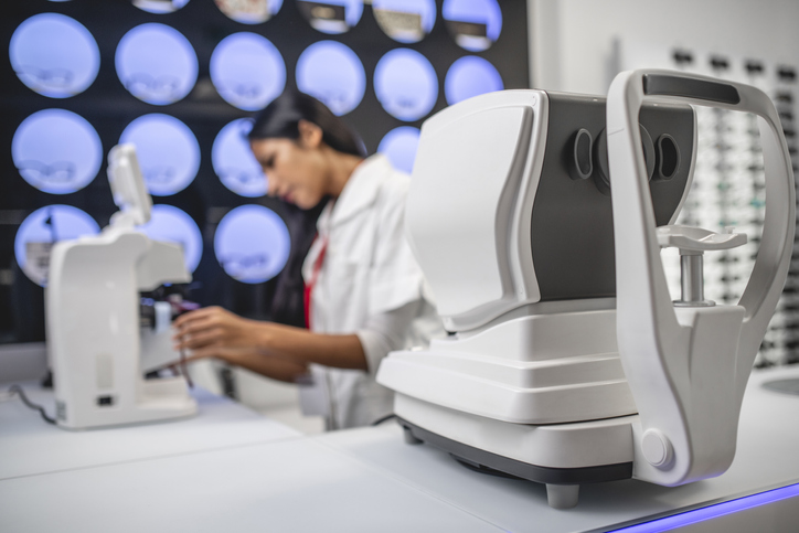 A medical professional looking at the results of an eye examination in an optometrist setting