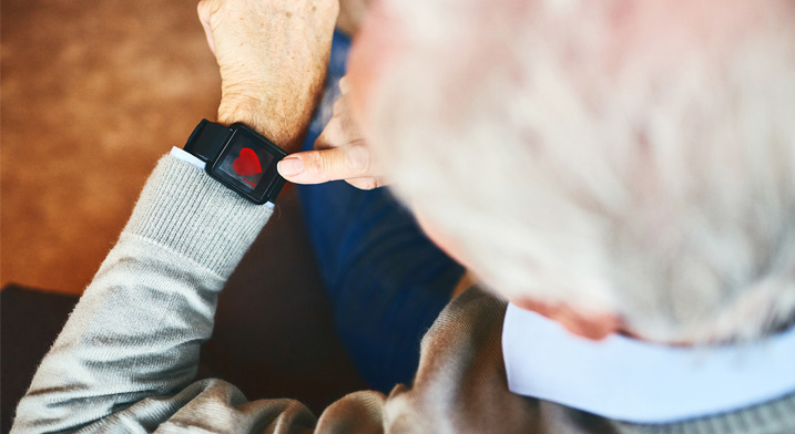 older man reading his heart rate on a smartwatch